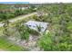 Aerial view of a charming home surrounded by lush greenery and mature trees in a serene setting at 5403 Fleming St, Port Charlotte, FL 33981