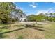 A peaceful backyard featuring shade trees and a lush lawn at 5403 Fleming St, Port Charlotte, FL 33981