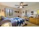 Bedroom with a ceiling fan, dresser, and view of window with blinds and exterior view at 5403 Fleming St, Port Charlotte, FL 33981