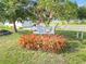 A sign for Gulf Cove Park & Boat Ramp, with colorful foliage, against a backdrop of green grass and trees at 5403 Fleming St, Port Charlotte, FL 33981