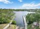 Scenic view of a well-maintained boat ramp leading into a calm waterway surrounded by lush greenery at 5403 Fleming St, Port Charlotte, FL 33981