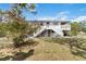 A charming home featuring a staircase leading to a spacious deck and well-maintained yard at 5403 Fleming St, Port Charlotte, FL 33981