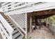 Exterior stairwell and storage under house with lattice and gravel yard at 5403 Fleming St, Port Charlotte, FL 33981