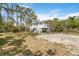 A charming home featuring a staircase leading to a spacious deck and well-maintained yard at 5403 Fleming St, Port Charlotte, FL 33981