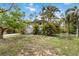 The home's charming exterior surrounded by lush landscaping offers privacy and curb appeal at 5403 Fleming St, Port Charlotte, FL 33981