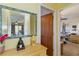 Hallway with mirror, wooden dresser, and doorway to bedroom with desk at 5403 Fleming St, Port Charlotte, FL 33981