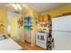Eat-in kitchen with white refrigerator and stove and view to adjoining rooms at 5403 Fleming St, Port Charlotte, FL 33981