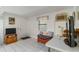 Bright living area with tile flooring, window, and an entertainment center at 5403 Fleming St, Port Charlotte, FL 33981