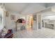 Open living space with tile flooring, leading to a bathroom and a functional kitchen area at 5403 Fleming St, Port Charlotte, FL 33981