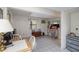 Open living space offering tile flooring, a functional kitchen area, and access to a side door at 5403 Fleming St, Port Charlotte, FL 33981
