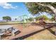 Community playground with swing sets, slide, picnic table, and lake view at 5403 Fleming St, Port Charlotte, FL 33981