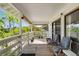 Exterior porch with sliding glass doors, chairs, potted plants, and a tranquil view at 5403 Fleming St, Port Charlotte, FL 33981