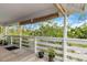 Inviting outdoor porch with chairs, greenery, bamboo shades, and a peaceful setting at 5403 Fleming St, Port Charlotte, FL 33981