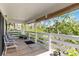 Spacious covered porch with outdoor seating, railing, and a scenic view at 5403 Fleming St, Port Charlotte, FL 33981