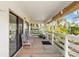View of the covered porch with railing, furniture, and sliding glass doors at 5403 Fleming St, Port Charlotte, FL 33981
