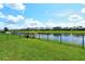 Well-maintained backyard featuring a black metal fence with tranquil views of a scenic lake at 5475 Summit Gln, Bradenton, FL 34203