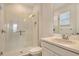 Bathroom with a glass-enclosed shower and a vanity with sink, complemented by natural light from the window at 5475 Summit Gln, Bradenton, FL 34203