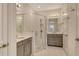 Modern bathroom featuring dual sinks, gray cabinets, and a glass enclosed shower at 5475 Summit Gln, Bradenton, FL 34203