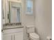 Elegant powder room features a marble countertop and window at 5475 Summit Gln, Bradenton, FL 34203