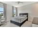 Comfortable bedroom featuring a tufted headboard, neutral tones, and ample natural light at 5475 Summit Gln, Bradenton, FL 34203