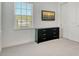 Clean and simple bedroom with a dresser, mounted television, and a bright window at 5475 Summit Gln, Bradenton, FL 34203