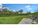A view of the expansive dog park with lush grass, mature trees, and a place to sit at 5475 Summit Gln, Bradenton, FL 34203