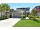 Charming two-story home with a well-manicured lawn, lovely landscaping, and an attached two-car garage at 5475 Summit Gln, Bradenton, FL 34203