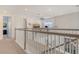 Second-floor hallway showcases the staircase and provides a glimpse into the living area at 5475 Summit Gln, Bradenton, FL 34203