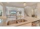 Stylish kitchen with a stainless steel sink, granite countertops, and an open view to the living area at 5475 Summit Gln, Bradenton, FL 34203