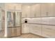 Contemporary kitchen with stainless steel refrigerator, white cabinets, and granite countertops at 5475 Summit Gln, Bradenton, FL 34203