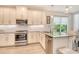 Modern kitchen featuring stainless steel appliances, granite countertops, and contemporary lighting at 5475 Summit Gln, Bradenton, FL 34203