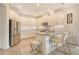Bright kitchen with white cabinets, stainless steel appliances, and a stylish island with seating at 5475 Summit Gln, Bradenton, FL 34203