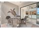 An outdoor dining space is presented in the screened-in lanai next to an open sliding glass door at 5475 Summit Gln, Bradenton, FL 34203