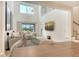 Cozy living room with a view of the pool, high ceiling, and modern chandelier at 5475 Summit Gln, Bradenton, FL 34203
