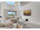 Bright living room with modern chandelier and sliding door to the backyard at 5475 Summit Gln, Bradenton, FL 34203
