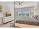 Bright main bedroom featuring a four-poster bed, ceiling fan, and a scenic outdoor view at 5475 Summit Gln, Bradenton, FL 34203