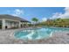 Resort-style swimming pool featuring ample seating and lush tropical landscaping at 5475 Summit Gln, Bradenton, FL 34203