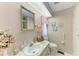 Cozy bathroom with framed mirror, marble countertop, and vertically striped wallpaper design at 5619 Bayshore Rd # 203, Palmetto, FL 34221