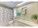 Charming bathroom with seashell wallpaper, vanity and shower curtain at 5619 Bayshore Rd # 203, Palmetto, FL 34221