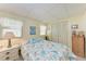 Comfortable bedroom with twin beds, decorative bedding, and natural light from two windows at 5619 Bayshore Rd # 203, Palmetto, FL 34221