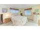 Bedroom features a queen-size bed, neutral carpeting, and ample natural light from two windows at 5619 Bayshore Rd # 203, Palmetto, FL 34221