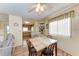 Bright dining area featuring natural light, ceiling fan, and an open view into the kitchen area at 5619 Bayshore Rd # 203, Palmetto, FL 34221