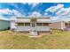 Exterior shot with white siding, awnings and minimal landscaping at 5619 Bayshore Rd # 203, Palmetto, FL 34221