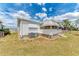 Well-maintained exterior featuring white siding, awnings, and mature landscaping at 5619 Bayshore Rd # 203, Palmetto, FL 34221