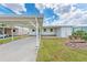 Well-maintained exterior showcasing the carport, entryway, and simple landscaping at 5619 Bayshore Rd # 203, Palmetto, FL 34221