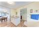 Hallway area reveals wood flooring, white cabinets, and entries to other rooms in the home at 5619 Bayshore Rd # 203, Palmetto, FL 34221