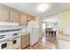 Kitchen shows wood cabinets, white appliances, and an open view into the dining and living areas at 5619 Bayshore Rd # 203, Palmetto, FL 34221