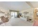 Bright living room with ample seating, a television, and a view of the sunroom at 5619 Bayshore Rd # 203, Palmetto, FL 34221