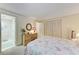 Bedroom shows a dresser with mirror, plush carpet, a ceiling and access to the ensuite bath at 5619 Bayshore Rd # 203, Palmetto, FL 34221