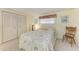 Bedroom with ample closet space features neutral carpeting, and a comfortable queen-size bed at 5619 Bayshore Rd # 203, Palmetto, FL 34221